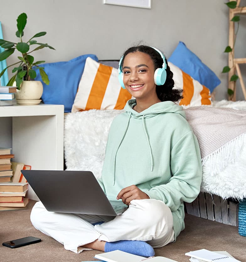 Teen girl on laptop computer in virtual iop program